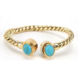 Unmarked gold rope twist and cabochon turquoise bangle, (tests as 15ct+ gold) 6.5cm wide, 13.5g :