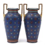 Mettlach, large pair of German stoneware vases with twin handles, hand painted and incised with