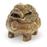 Chinese patinated bronze incense burner in the form of a Foo dog, four figure character marks to the