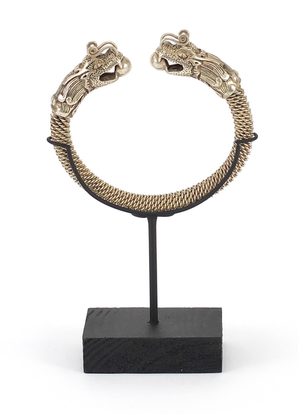 Tibetan silver coloured metal dragon bangle on stand, 17cm high : For Further Condition Reports - Image 4 of 7