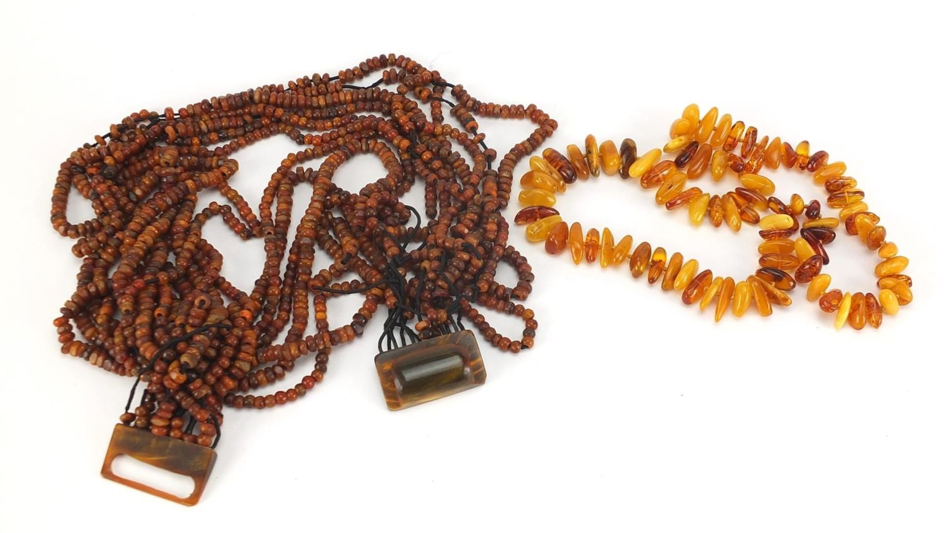 Butterscotch amber coloured bead necklace and a twelve row amber coloured necklace, total 244.2g :