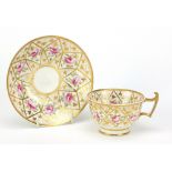 Early 19th century porcelain cup and saucer hand painted with roses, the saucer 13.5cm in diameter :