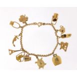 18ct gold charm bracelet with a selection of 9ct and 18ct gold charms including Eiffel Tower,