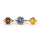 Three gold rings comprising 18ct gold with citrine and two 9ct gold, sizes J, K and L, total 9.