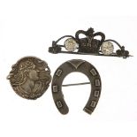 Silver jewellery comprising Victorian horseshoe brooch, coronation brooch and Art Nouveau pendant,