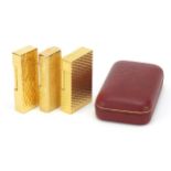 Three vintage gold plated pocket lighters comprising Dunhill with fitted case, S J Dupont and