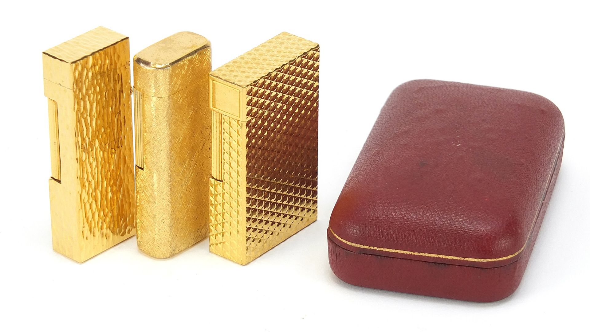 Three vintage gold plated pocket lighters comprising Dunhill with fitted case, S J Dupont and