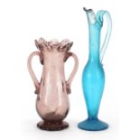 Antique purple glass vase with twin handles and a blue glass jug with writhen body, the largest 25.