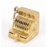 9ct gold charm in the form of a Victorian cash register opening to reveal a drawer of money, 1.2cm