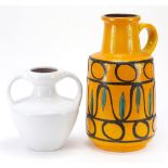 1970's West German pottery comprising handled jug and a twin handled vase, the largest 39.5cm high :