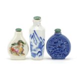Three Chinese porcelain snuff bottles including a blue and white example decorated with a river
