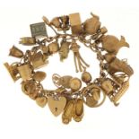 Good 9ct gold charm bracelet with a large selection of mostly gold charms including a rigged sailing