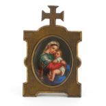 19th century gilt metal easel frame housing a religious porcelain panel hand painted with Madonna
