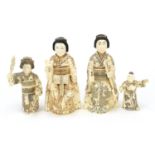 Four Japanese bone figures including one of a young boy holding a peach, the largest 21cm high : For