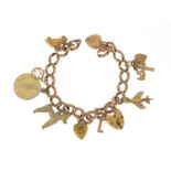 9ct rose gold charm bracelet with a selection of gold and metal charms including love heart padlock,