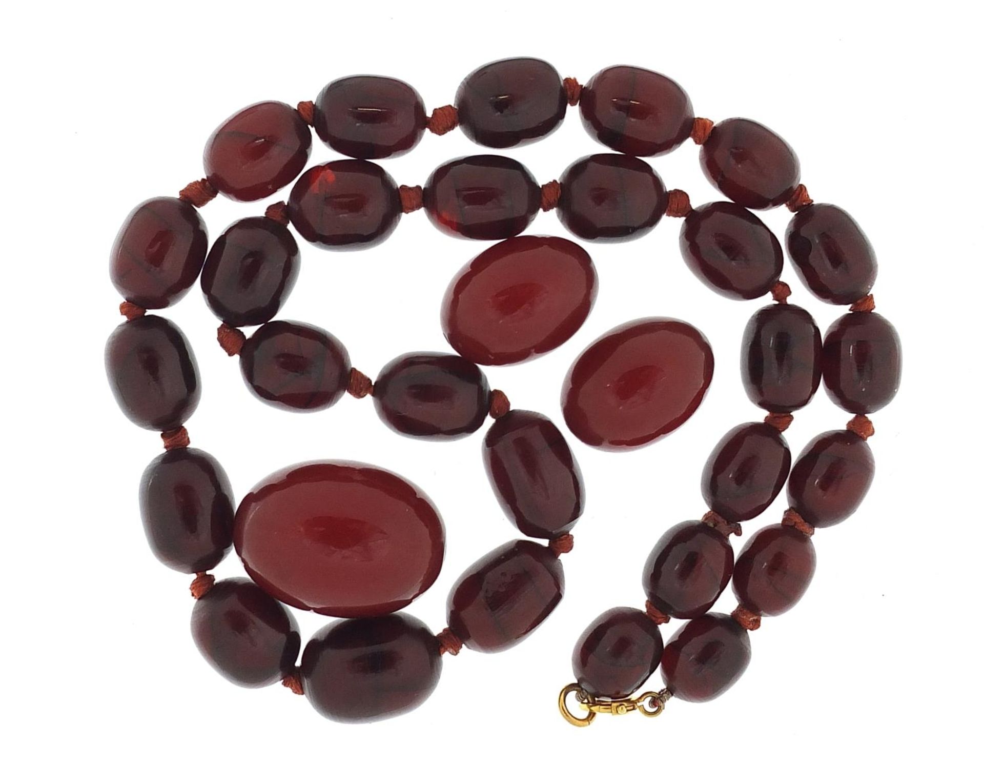 Cherry amber coloured bead necklace and three beads, the necklace 48cm in length, total 49.7g : - Image 2 of 2