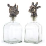 Pair of glass decanters with rhinoceros and giraffe head stoppers, 24cm high : For Further Condition