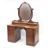 Victorian mahogany dressing table with swing mirror back and a series of twelve drawers, 170cm H x