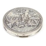 Danish silver coloured metal compact, the hinged lid embossed with merry figures in a courtyard, 8cm