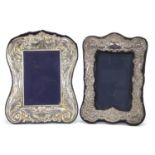 Rectangular silver easel photo frame and one other, the silver example embossed with birds amongst