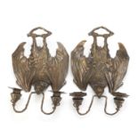 Pair of Art Nouveau style patinated bronze two branch bat design wall sconces, each 36cm high :