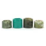 Four Chinese green hardstone thumb rings, the largest 3cm high : For Further Condition Reports