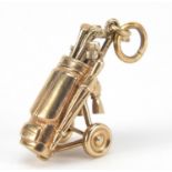 9ct gold golf club and caddy charm, 3cm high, 6.5g : For Further Condition Reports Please Visit