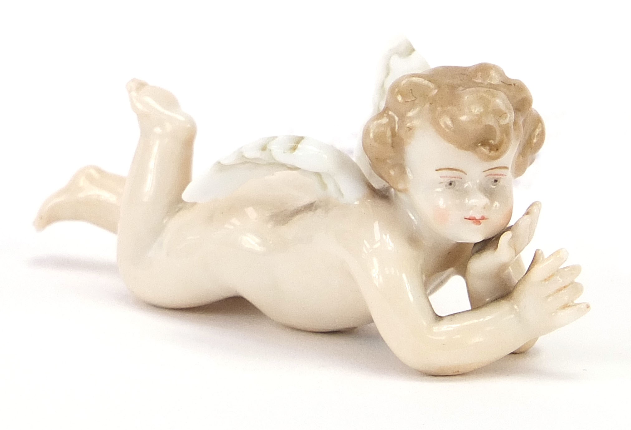 19th century Meissen style porcelain figure of Putti, 8.5cm in length : For Further Condition