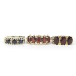 Three 9ct gold rings comprising two with garnets and one with sapphires and diamonds, sizes L, Q and