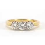 18ct gold diamond three stone ring, the central diamond approximately 4.2mm in diameter, size O, 3.