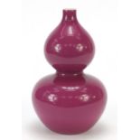 Chinese porcelain double gourd vase having a pink glaze, six figure character marks to the base,