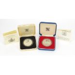 Two commemorative silver proof crowns with fitted cases including one commemorating the 80th