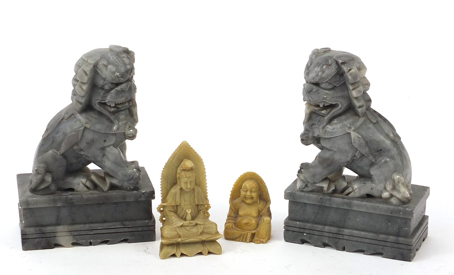 Chinese stone carvings including a pair of Foo dogs and a Buddha, the largest each 18cm high : For