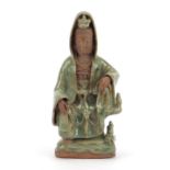 Chinese pottery figure of Guanyin having a celadon glaze, 21.5cm high : For Further Condition