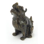 Chinese patinated bronze Foo dog, four figure character marks to the underside, 16.5cm high : For