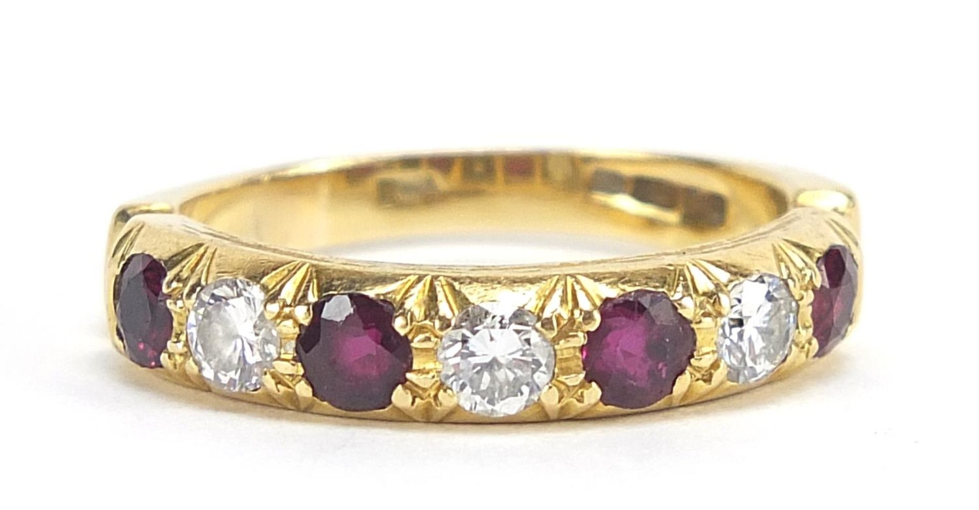 18ct gold diamond and ruby half eternity ring, the diamonds approximately 3.2mm in diameter, size R,