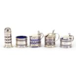 Five silver cruets with blue glass liners including three mustards with hinged lids, various