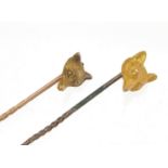 Two Victorian unmarked gold fox head stick pins, the largest 6cm in length, total 3.0g : For Further