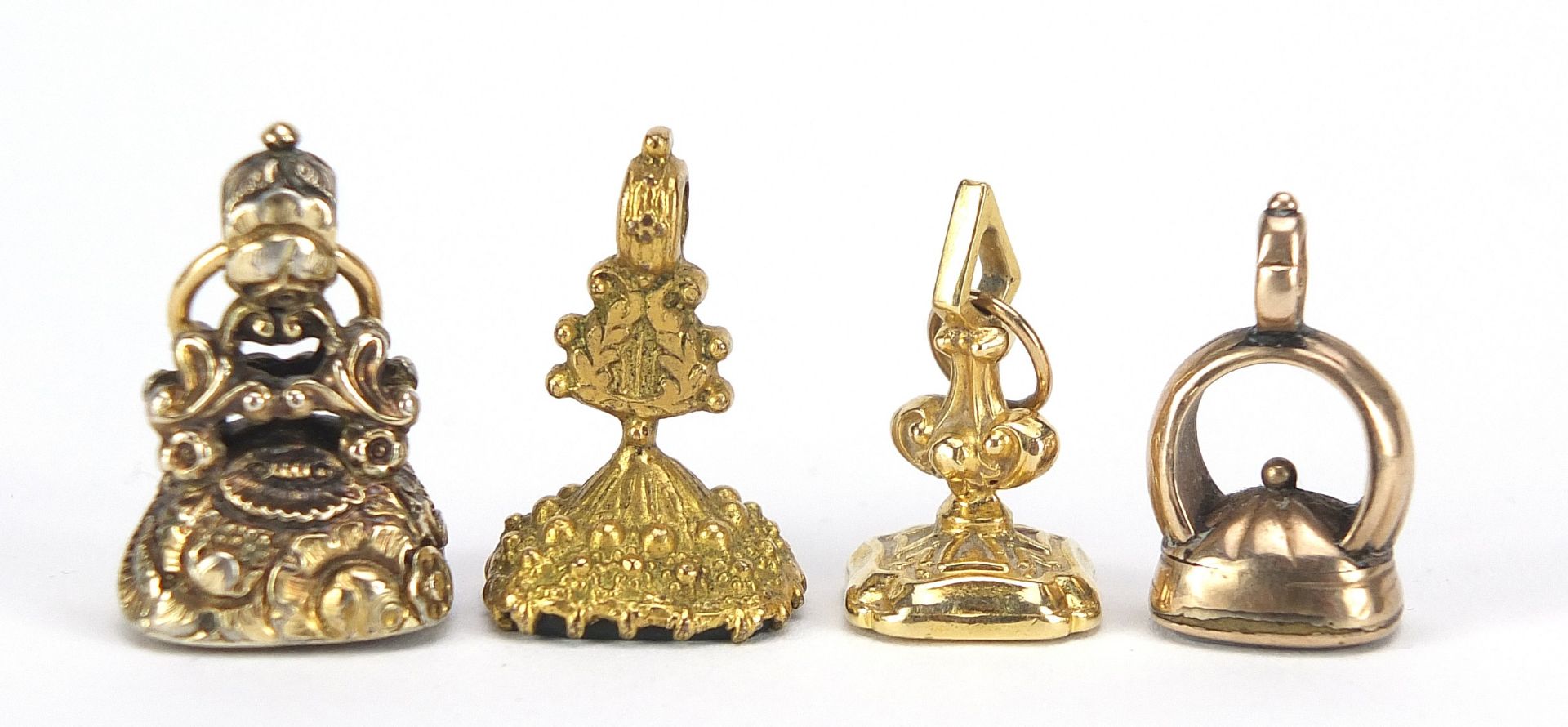 Four Georgian and later unmarked gold and gold coloured metal intaglio seal fobs, the largest 2.