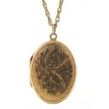 Oval 9ct gold locket with engraved decoration on a 9ct gold necklace, 3cm high and 60cm in length,