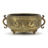 Chinese patinated bronze tripod incense burner with twin handles decorated in relief with phoenixes,