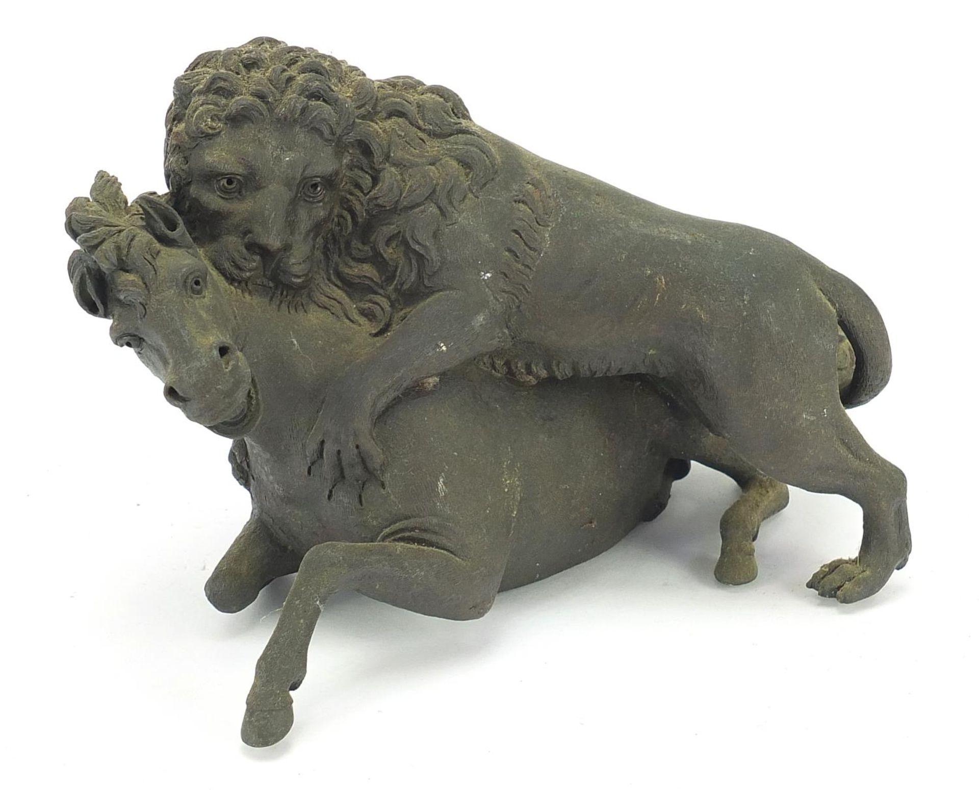 Antique patinated bronze group of a lion attacking a horse, 18cm wide