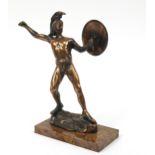 Bronzed figure of a Roman style warrior holding a shield standing on a marble plinth, 31cm high