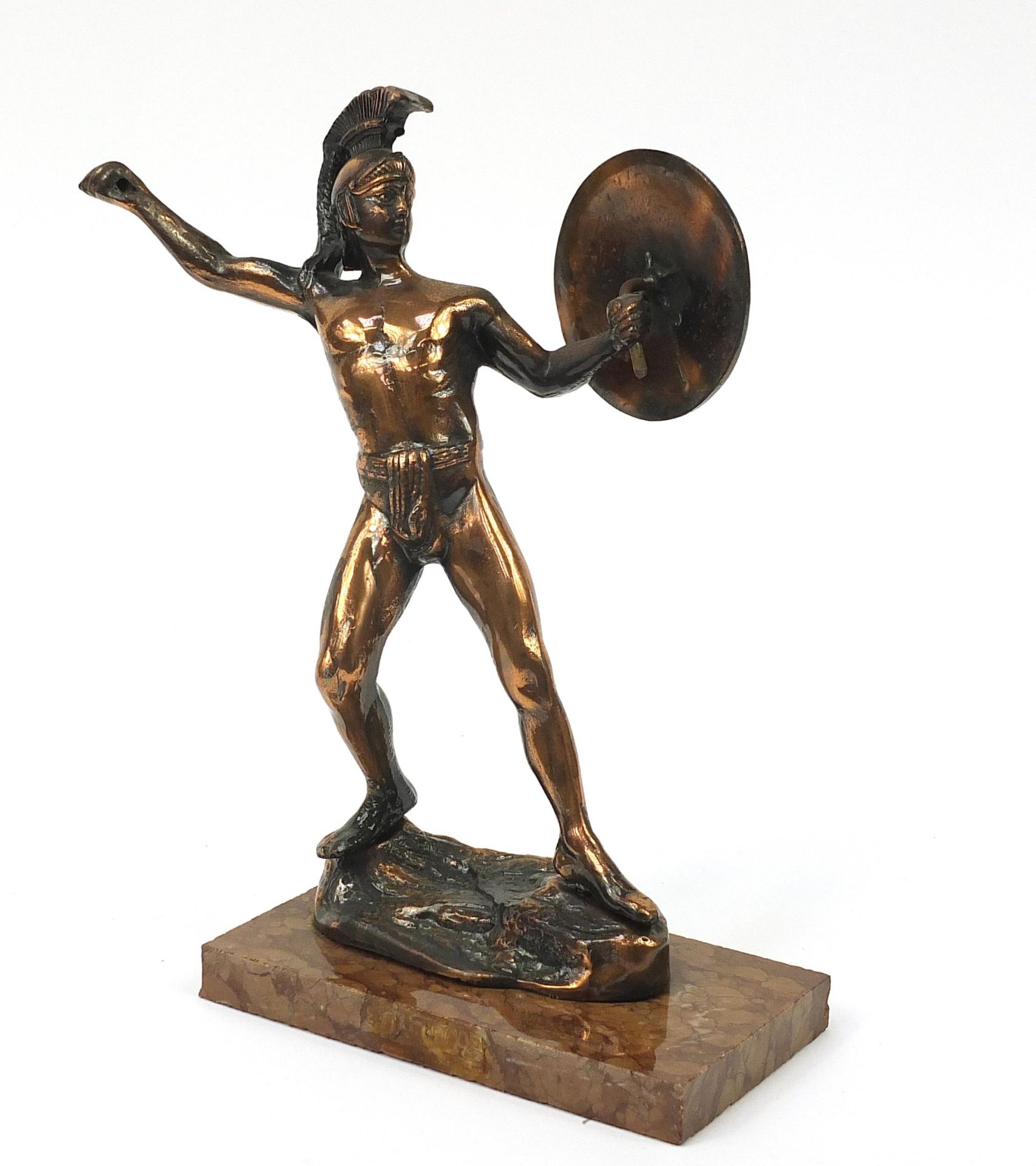 Bronzed figure of a Roman style warrior holding a shield standing on a marble plinth, 31cm high