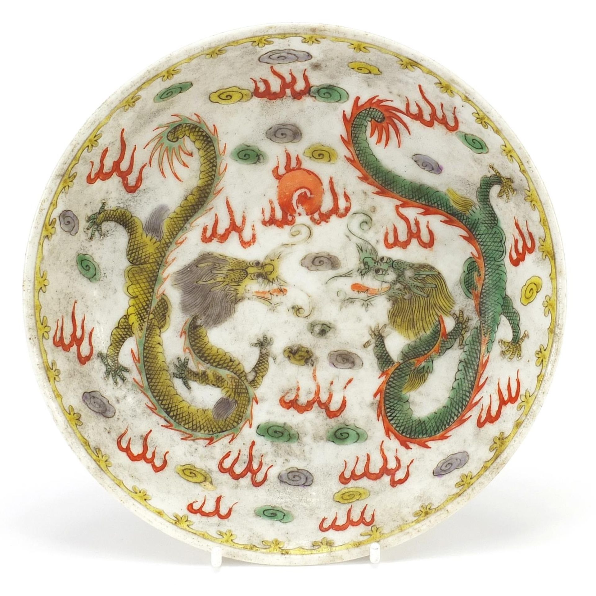 Chinese porcelain dragon dish hand painted in the wucai palette with two dragons chasing a flaming