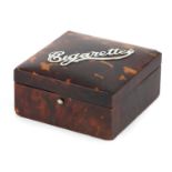 Square tortoiseshell cigarette box with the words Cigarettes in hallmarked silver on the lid, the
