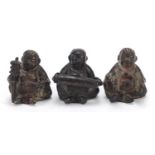 Three Chinese bronzes of musicians seated playing various instruments, the largest 4cm high