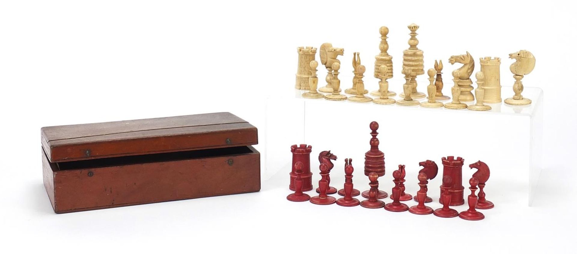 Half stained carved bone chess set and a mahogany case, the largest chess pieces 8.5cm high