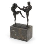 Patinated bronze study of two mixed martial artists raised on a rectangular marble base, 26cm high