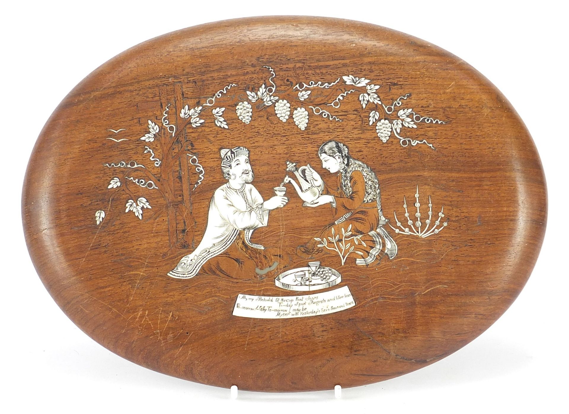 Indian rosewood plaque with ivory inlay of a man and woman drinking tea, 29cm x 21cm